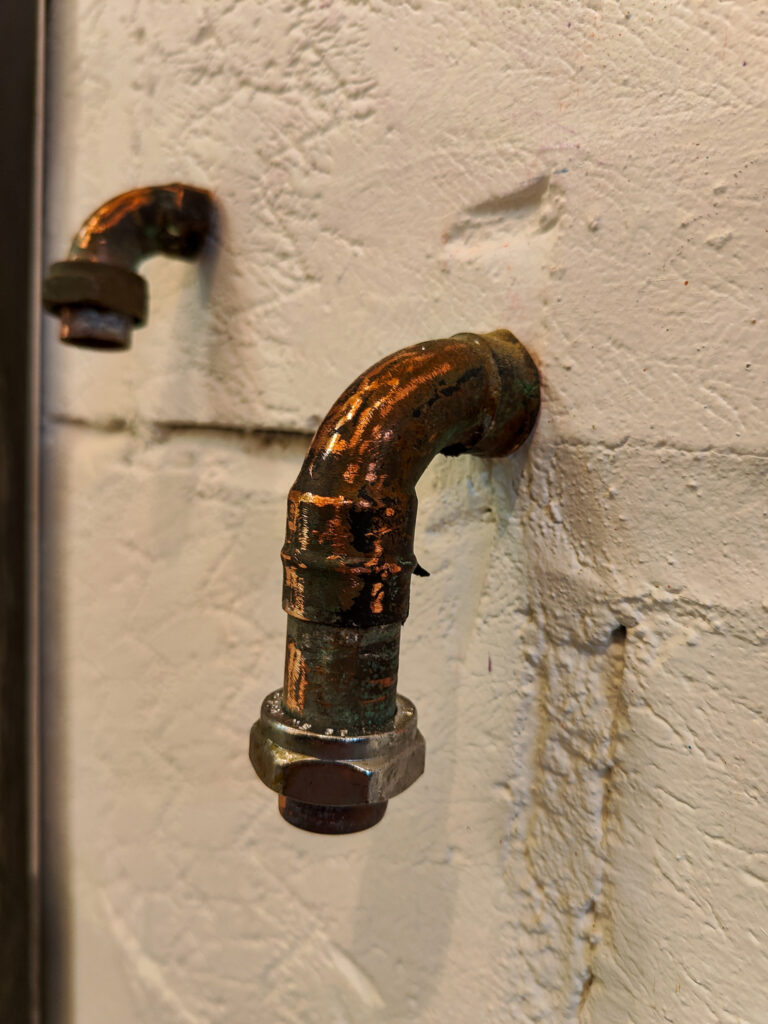 Pipe-based sculptural installation exploring masculinity, industrial infrastructure and queer material aesthetics